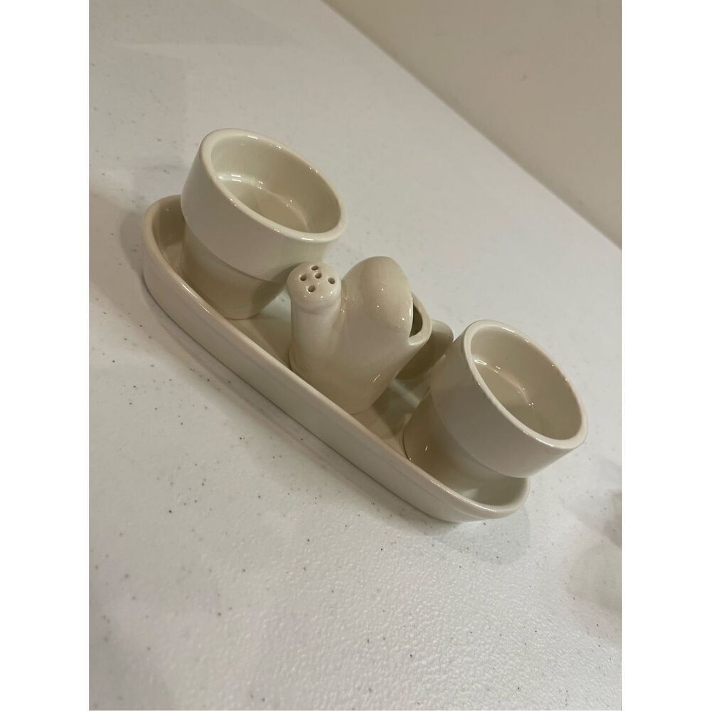 Mini white clay pots with watering can on tray